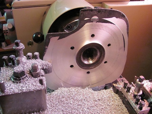 Skimming some excess metal off head to move combustion chamber back down cylinder.